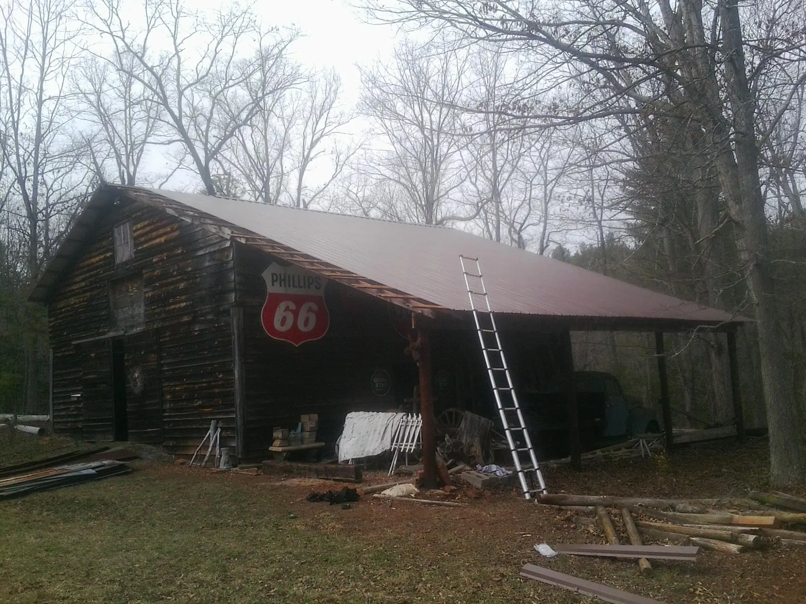 New metal roof on an open sided timber barn with a vintage sign in Bonfield